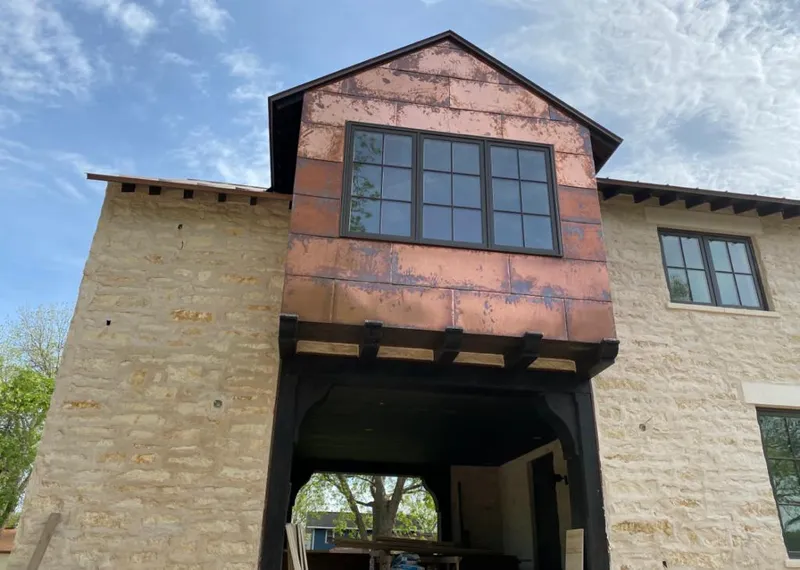 Copper metal panel facade on a stone building for Skylight Installation in Annapolis Neck